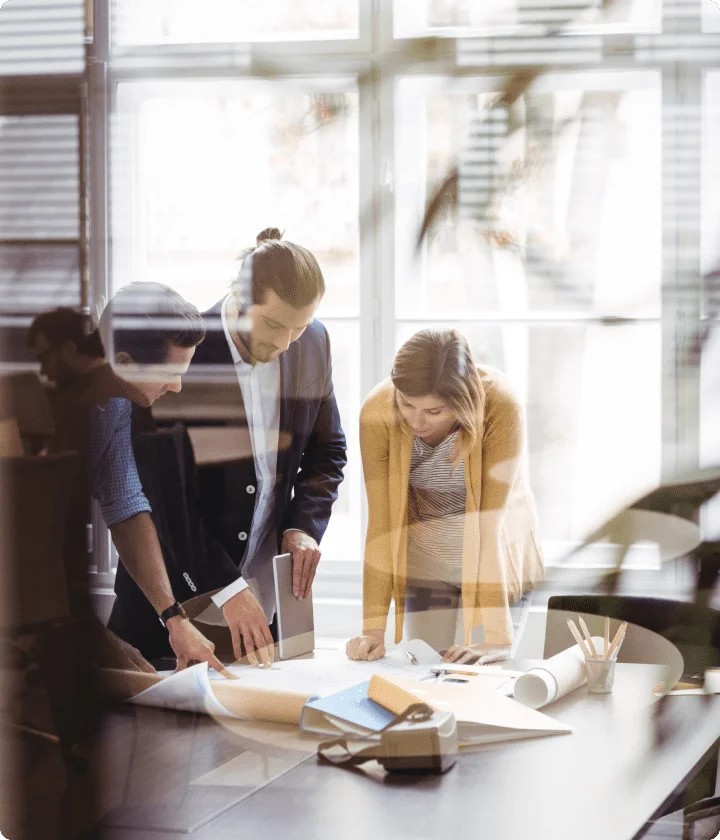 male and female business people assess a project at a table